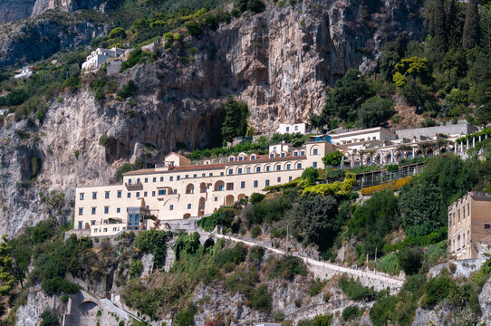 Facades of famous town of Amalfi, located on the Amalfi Coast, with its azure sea and beautiful colorful cliffside houses.