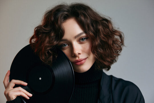 Young Brunette Woman Holding Vintage Vinyl Record