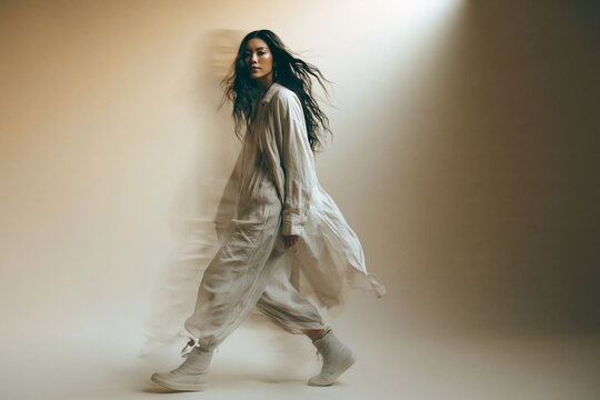 Fashionable Asian Woman Walking with Motion Blur Effect