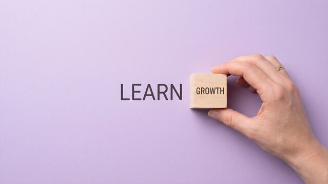 Hand placing wooden block with growth word next to learn text on purple background for self improvement