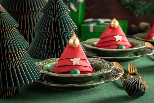 Bottle green dining setup with festive baubles.