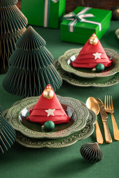 Sleek green table decorated with holiday baubles.