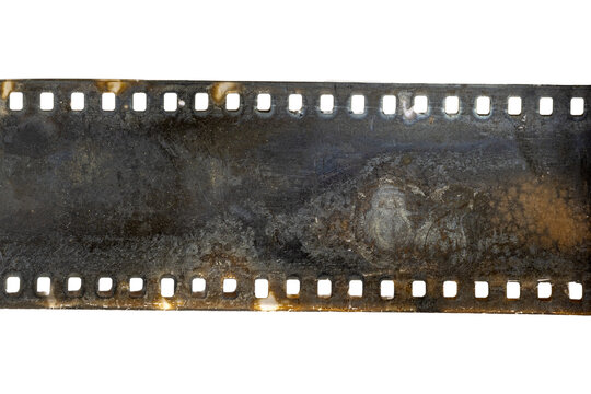 Damaged corroded 35mm film strip with perforations and residue