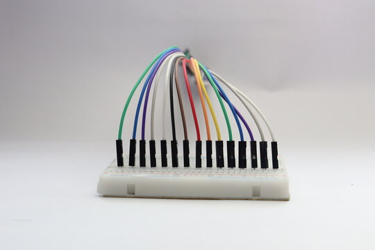 Neatly arranged jumper wires connected to a breadboard close up view