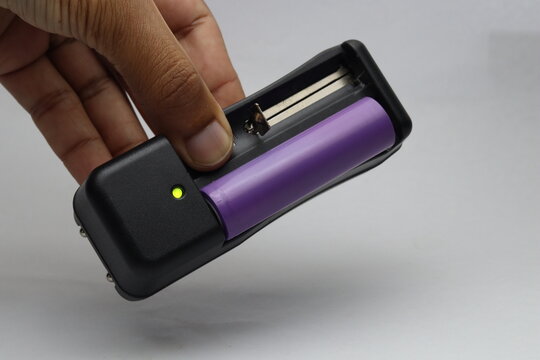 Lithium ion battery portable charger with battery inserted and indicator LED glowing