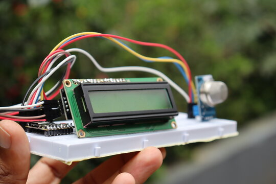 Breadboard circuit with focus on the LCD module and gas sensor module blurred in the background