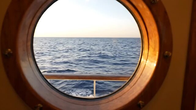 Ship Portholes Reveal a Calm Ocean View with Gentle Waves and a Bright, Sunny Sky. Seamless Looping Footage of Maritime Travel.