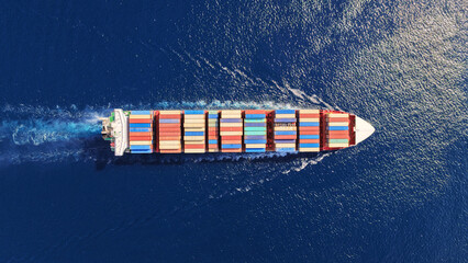 Aerial drone top down photo above huge size container ship cruising deep blue Mediterranean sea © aerial-drone