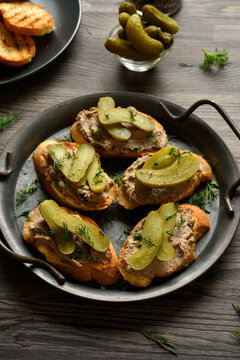 Open sandwiches with liver pate on wooden table