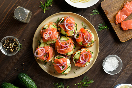 Smoked salmon toasts with cream cheese, fresh cucumber and greens