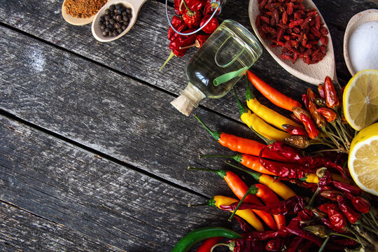  seasonings for cooking, varieties of hot chilli pepper, ground pepper and spices, oil. for the text recipe	