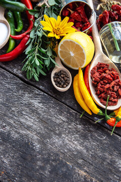  seasonings for cooking, varieties of hot chilli pepper, ground pepper and spices, oil. for the text recipe	