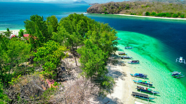 Aerial drone view of Gili Nanggu island on a sunny day showing turquoise lagoon white sand beaches and coral reefs Lombok Indonesia