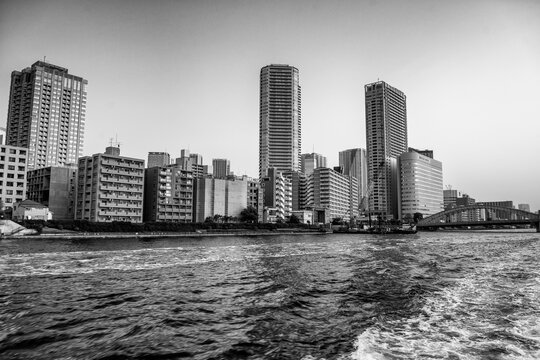 Ferry perspective of Tokyo&rsquo;s Sumida-gawa River with Chuo district skyscrapers and urban waterfront scenery