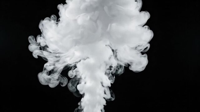 Dense white smoke rising and expanding upward rapidly against black