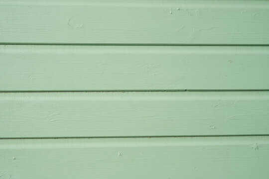 Mint green painted wooden boards with subtle grain and horizontal lines