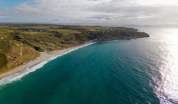 Aerial landscape from the sea of the Cornish village of Sennen Cove in Cornwall, UK at sunset