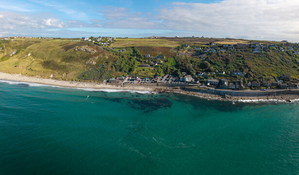 Aerial landscape from the sea of the Cornish village of Sennen Cove in Cornwall, UK at sunset
