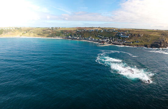 Aerial landscape from the sea of the Cornish village of Sennen Cove in Cornwall, UK at sunset