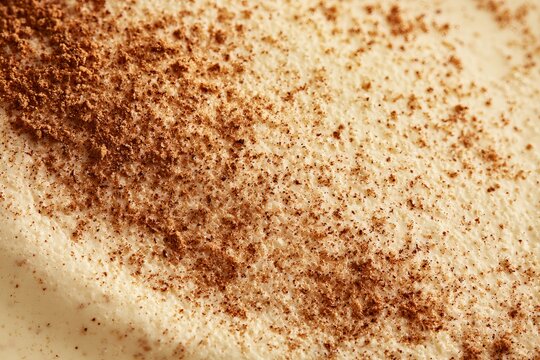 Creamy dessert topped with cinnamon spice in a close-up view