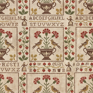 Vintage cross stitch sampler pattern featuring intricate floral urns birds and alphabet typography on textured linen fabric for traditional textile design and nostalgic craft projects