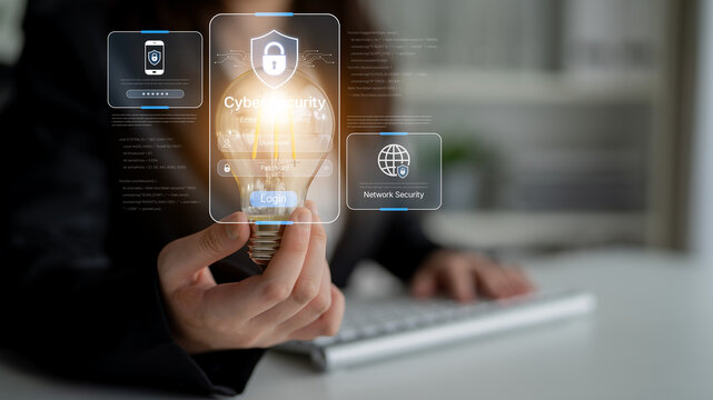 A business professional illustrates cyber security concepts while holding a glowing light bulb, symbolizing innovation and protection in a modern office environment. Nascent