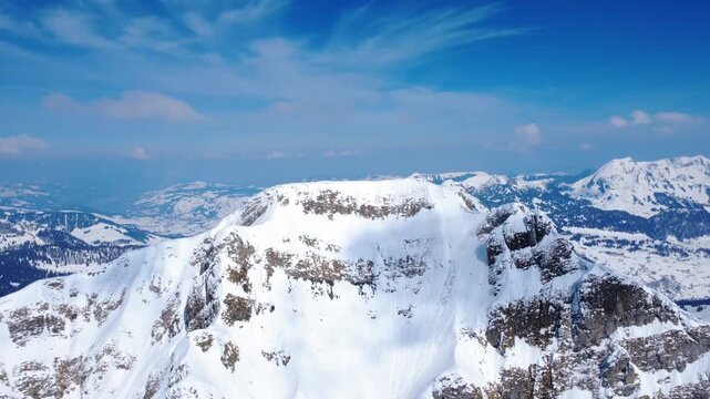 Aerial view of layered limestone cliffs with snow in the Swiss Alps