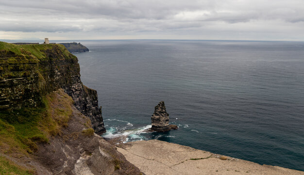 Scenic view of the An Branan Mor sea stack and OBriens Tower on the Cliffs of Moher, County Clare, Ireland.