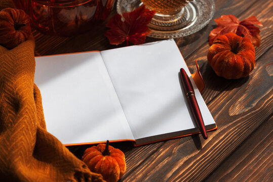 Cozy Autumn Scene With Open Notebook Pumpkins And Warm Beverage For Seasonal Storytelling