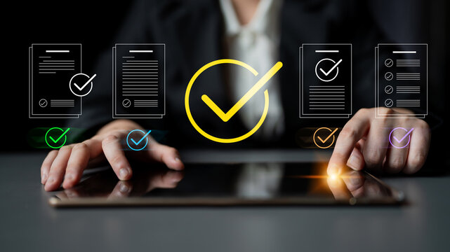 A business professional interacts with a digital tablet to review documents, showcasing checkmarks and graphics that illustrate the approval process in a modern workspace. Cyphers