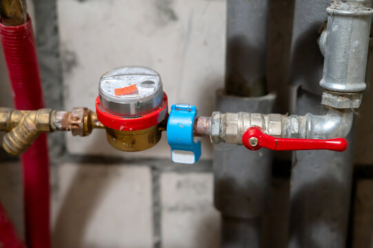 
Single water meter in a plumbing system with pipes and valves. Water consumption monitoring, resource conservation, reduced usage, and utility cost control.

