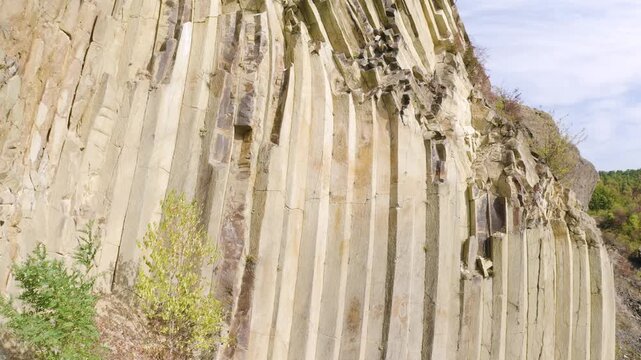 Drone footage of basalt columns near Sylce in Ukraine&rsquo;s Carpathians, hexagonal prisms formed by volcanic lava cooling millions of years ago, surrounded by autumn forest with bicycle for scale