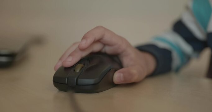 Close-up children's hand use computer mouse. 4K 10-bit