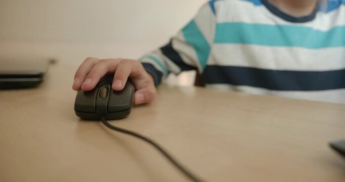 Close-up children's hand use computer mouse. 4K 10-bit