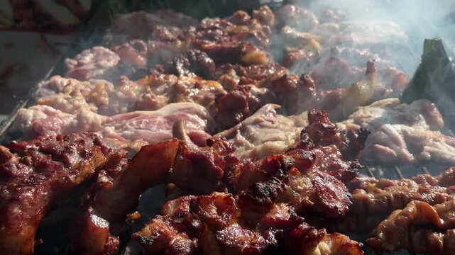 Grilled meat smoking on outdoor charcoal barbecue in Chiang Mai