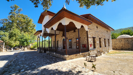Historic Şaban Ağa Mosque in Eskihisar, Stratonikeia, Yatağan, Muğla, rebuilt in 1876 with an elegant timber-columned prayer porch featuring painted ceiling decorations, adjacent to Roman ruins and th © cilicia