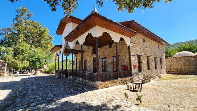 Historic Şaban Ağa Mosque in Eskihisar, Stratonikeia, Yatağan, Muğla, rebuilt in 1876 with an elegant timber-columned prayer porch featuring painted ceiling decorations, adjacent to Roman ruins and th