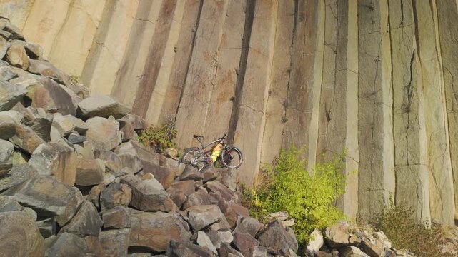 Drone footage of basalt columns near Sylce in Ukraine&rsquo;s Carpathians, hexagonal prisms formed by volcanic lava cooling millions of years ago, surrounded by autumn forest with bicycle for scale