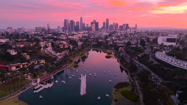 Aerial footage of Echo Park and downtown Los Angeles city skyline and skyscrapers during golden at sunset.	