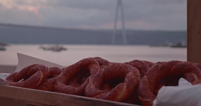 Traditional Turkish Sesame Simit on Street Stall with Bosphorus in Background
