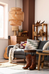 Western interior design and rustic home decor, cozy living room with cowboy boots and guitar in a warm sunlit apartment with bohemian style furniture © Pixel-Shot