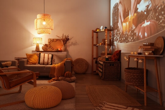 Hygge lifestyle and cozy home atmosphere, living room interior with warm lighting and autumn decor for relaxation and comfort during fall season