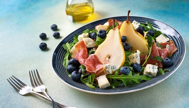 salad with pear arugula jamon blue cheese and blueberry delicious fresh salad appetizer on bright background
