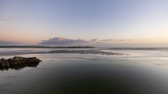 beautiful sunset and dusk light falling upon Grotto lagoon and rock formations, Hermanus, South Africa