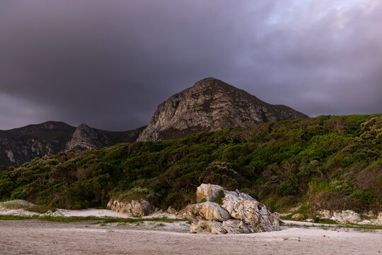 beautiful sunset and dusk light falling upon Grotto lagoon and rock formations, Hermanus, South Africa