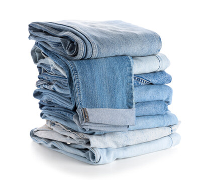 Sustainable fashion and circular economy, stack of folded blue denim jeans for clothing retail and textile recycling concept isolated on white background