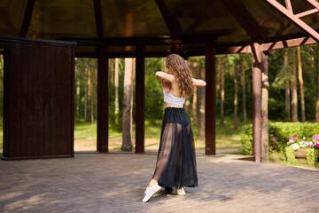 Dynamic caucasian dancer practicing near pavilion column © diczman