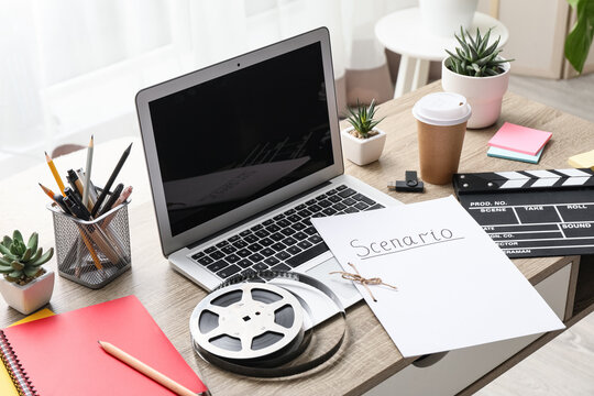 Film production and screenwriting concept, laptop with scenario script and movie clapperboard on a creative office desk for media and entertainment industry