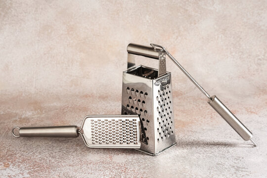 Food preparation and culinary tools, stainless steel box grater and handheld zester for cooking and meal prep in a modern kitchen environment