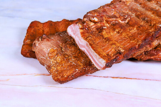 Cooked meat smoked ribs placed on food appears ready to eat
